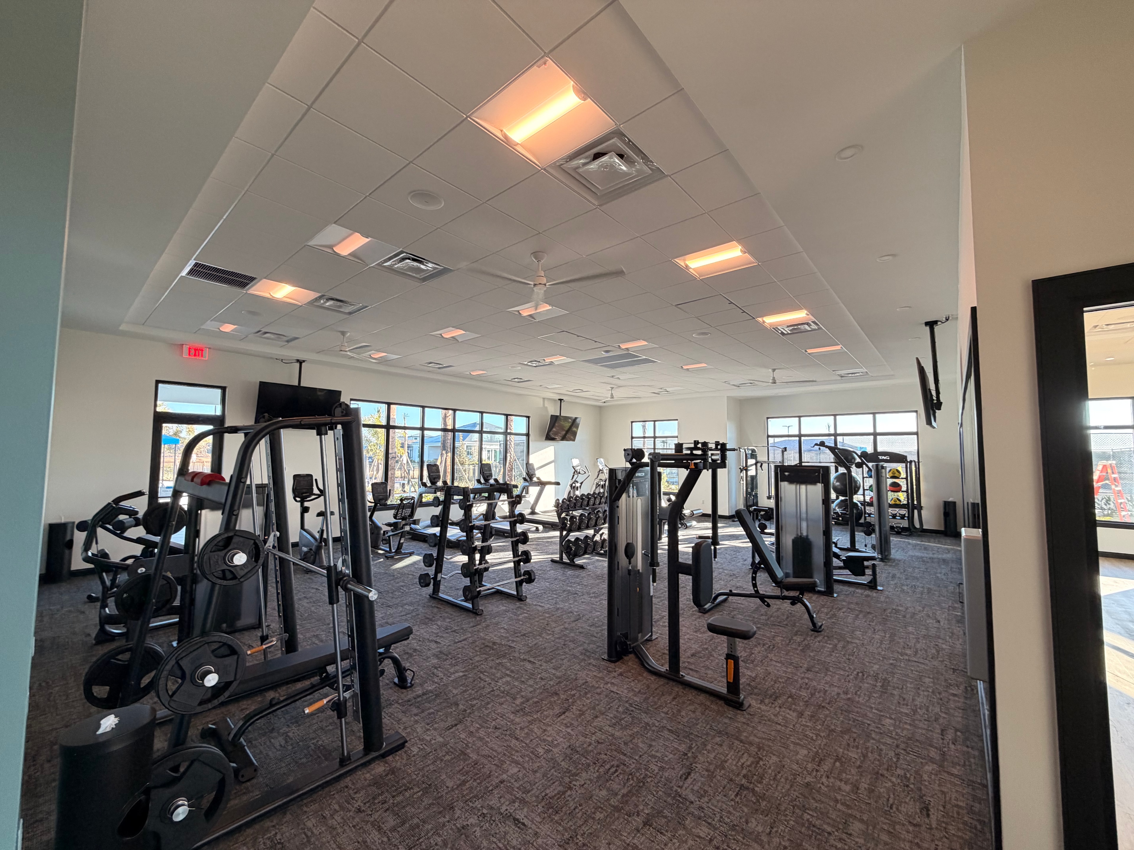 Commercial gym interior with fitness equipment and lighting