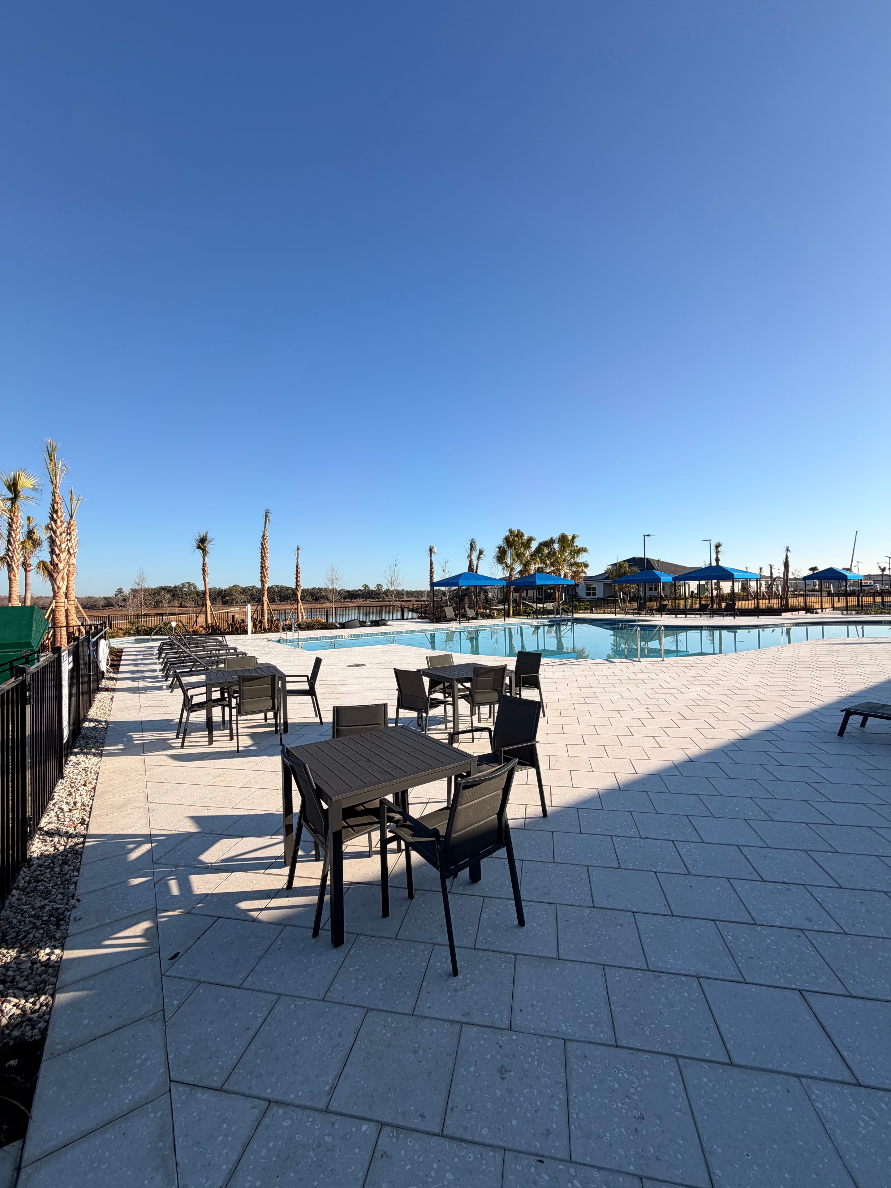 Poolside outdoor seating area with blue sky