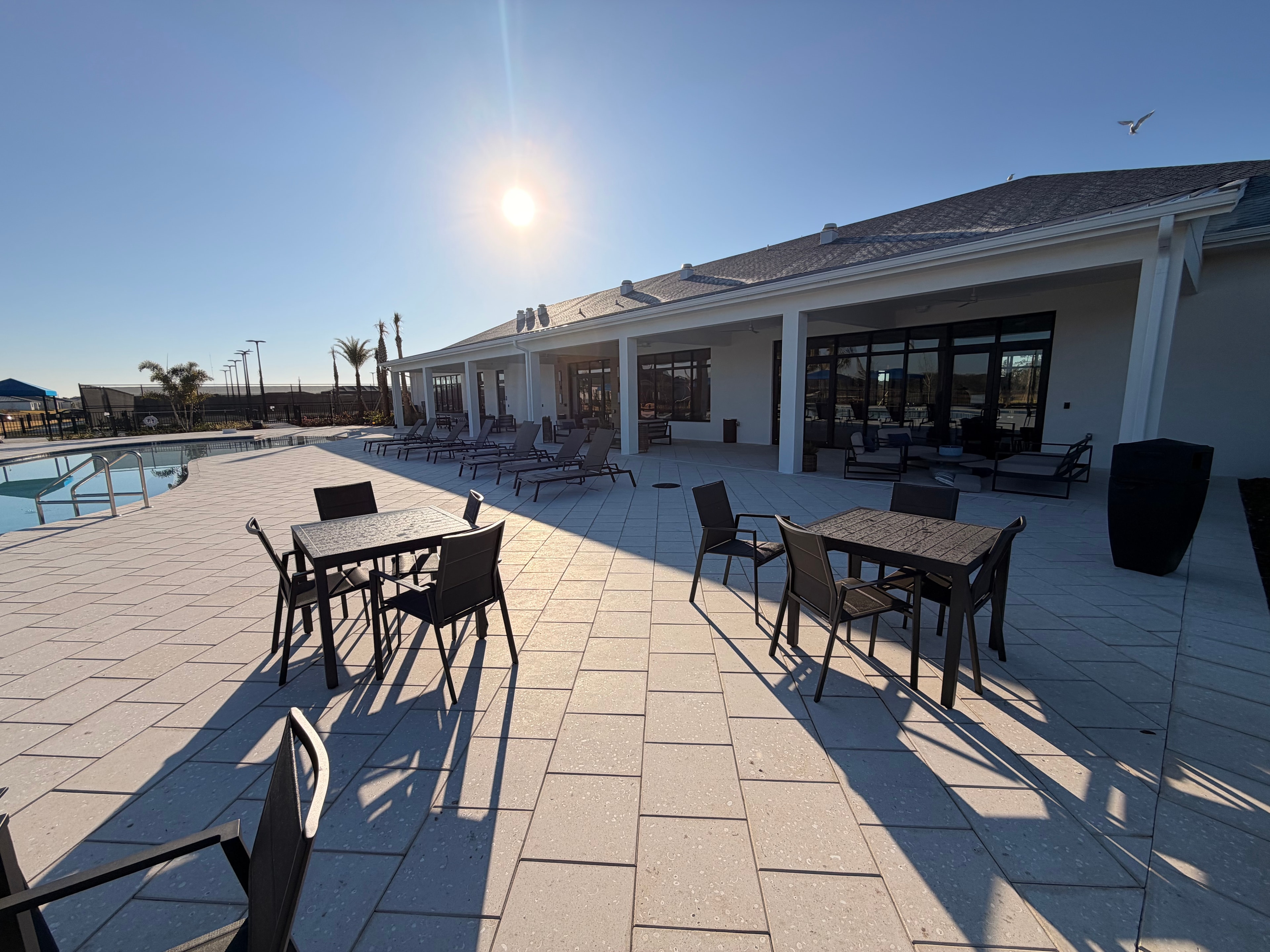 Clubhouse pool deck with outdoor dining and seating