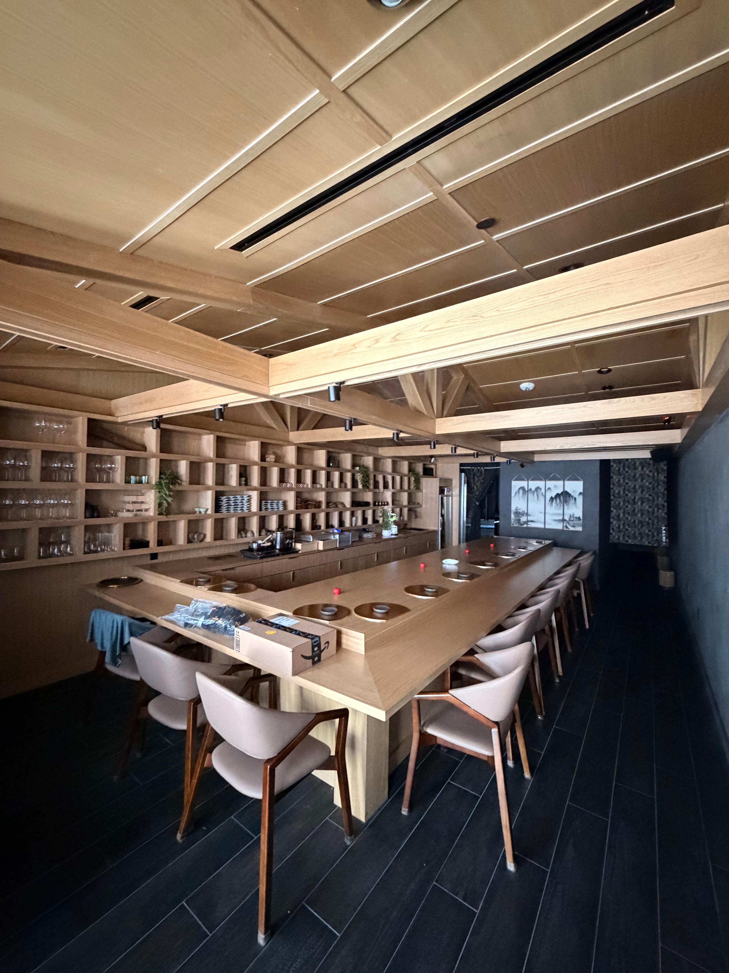 Restaurant bar interior with custom wood shelving and lighting