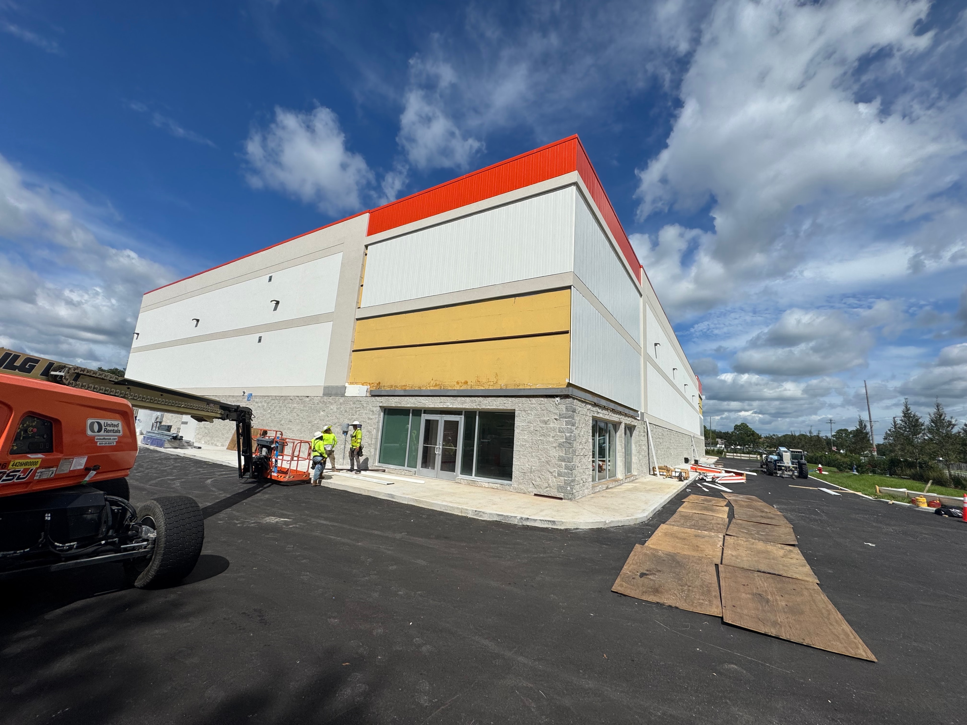 Public Storage building under construction corner view with boom lift