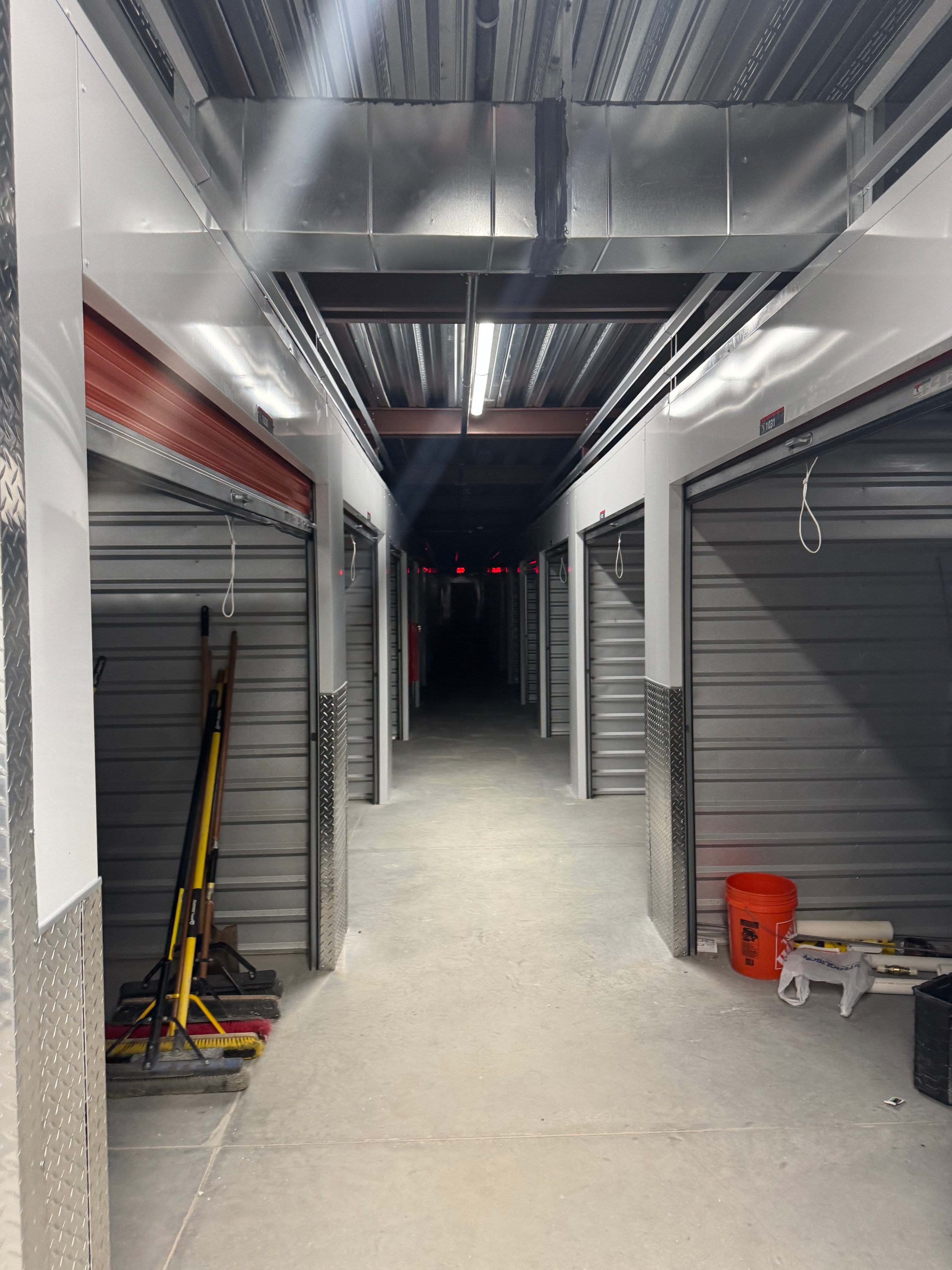 Public Storage interior storage hallway with red emergency lighting