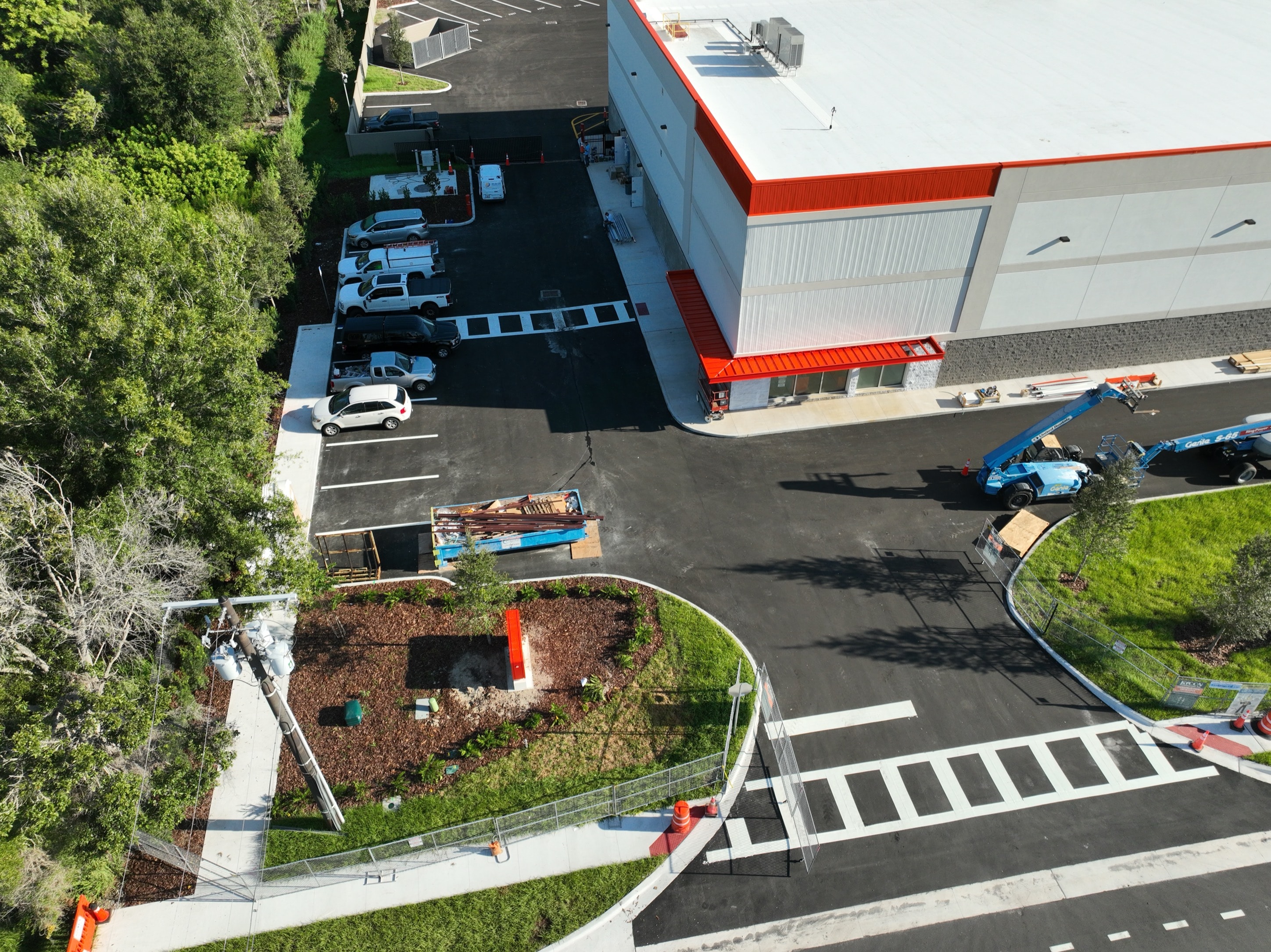 Public Storage facility aerial drone view with crew trucks on site